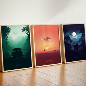 May include: Three framed art prints with nature-themed illustrations. The prints feature landscapes with silhouettes of animals, dragons, and figures. The color palettes include shades of green, orange, and blue, with text at the bottom of each print.