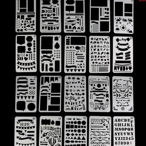 May include: Set of 20 black and white plastic stencils with various designs, including banners, arrows, hearts, stars, numbers, letters, and other decorative elements. The stencils are arranged in a grid pattern on a black background.