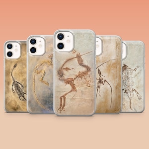 May include: Set of four iPhone cases featuring different fossilized dinosaur skeletons on a beige background.