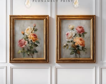 Puede incluir: Dos estampados florales enmarcados con ramos de rosas en tonos rosa, amarillo y naranja. Los estampados están en marcos dorados ornamentados y cuelgan de una pared blanca. El texto "PUDNAMBUT PRINT" está encima de los marcos.