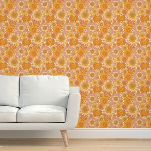 May include: A vintage-style wallpaper featuring a repeating pattern of orange, yellow, and pink flowers. The flowers are arranged in a tight, geometric pattern, creating a busy and vibrant look.