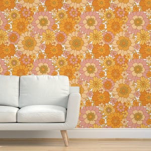 May include: A vintage-style wallpaper featuring a repeating pattern of orange, yellow, and pink flowers. The flowers are stylised and have a retro 70s aesthetic.