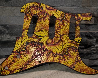 Pode incluir: Um protetor de guitarra amarelo e vermelho com um padrão floral detalhado.