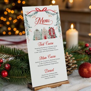May include: A Christmas menu card with a festive design, featuring a watercolor illustration of houses and greenery. The menu is displayed on a wooden stand, surrounded by holiday decorations, including candles, ornaments, and pine branches.
