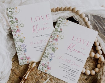 May include: Two floral bridal shower invitations with pink and white text that reads "Love in Bloom" and "Join us for a bridal shower honoring Charlotte Jason". The invitations are decorated with watercolor floral illustrations.