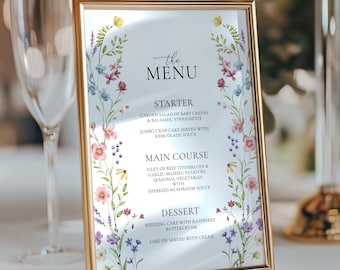 Könnte beinhalten: Ein rechteckiges, goldgerahmtes Menü mit floralen Akzenten. Die Speisekarte listet Vorspeisen, Hauptgerichte und Desserts auf. Der florale Rand ist mit Aquarellblumen in Rosa, Lila und Gelb verziert.