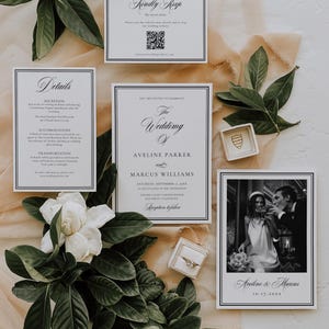 May include: Wedding invitation suite featuring a central invitation card with the names Aveline Parker and Marcus Williams. Includes RSVP, details, and a photo card. The design is elegant, with a black and white color scheme, and is accented with greenery and a white flower.
