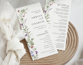 May include: Wedding ceremony program with floral border. The program includes the names Amelia and Charlie, the date Saturday, July 24, and the location San Diego, CA. The program also includes the order of the ceremony, including the prelude, seating of the family, processional, opening words, reading, exchange of vows, exchange of rings, prayer, presentation of the couple, and recessional.
