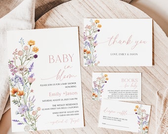 May include: A floral baby shower invitation with a pink and white color scheme. The invitation features a watercolor illustration of wildflowers and the text "Baby in Bloom" with the names "Emily + Jason". The invitation also includes the date, time, and location of the shower. The text "RSVP by August 10th to Sarah 000-000-0000" is also included. The invitation is decorated with a floral border.