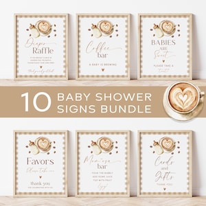 May include: A bundle of ten baby shower signs with a coffee theme. Each sign features a latte art design, a baby bottle, and text such as "Diaper Raffle" and "Coffee Bar." The signs have a beige and brown color scheme.
