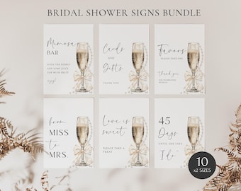 May include: A set of ten printable bridal shower signs featuring champagne glasses with gold accents and pearl details. The signs include phrases like "Mimosa Bar", "Cards and Gifts", "Favors", "From Miss to Mrs.", "Love is Sweet", and "45 Days Until She Says "I Do"".