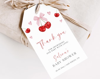 May include: A white thank you tag with red cherries and pink hearts. The text reads "Thank you for showering our baby with love! Selena's Baby Shower 28.08.20xx | San Diego, CA"