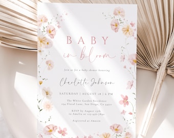 May include: A baby shower invitation with the words "BABY in bloom" in pink script. The invitation is decorated with watercolor flowers in shades of pink and yellow. The details include the honoree's name, date, time, and location.