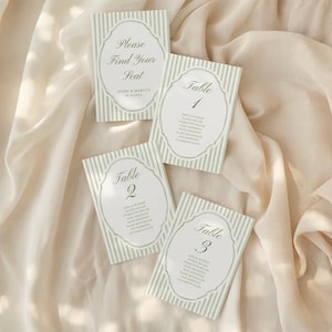 May include: Four rectangular place cards with a light green and white striped design. Each card features an oval frame with text. One card reads "Please Find Your Seat", the others read "Table 1", "Table 2", and "Table 3".