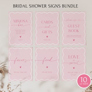 May include: Pink bridal shower signs with white borders and pink hearts. The signs include the text: "Mimosa Bar", "Cards and Gifts", "Guest Book", "Favors", "Food", and "Love is Sweet".