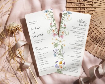 May include: Wedding ceremony program with floral illustrations. The program includes the names Avery and Oliver, the date Saturday, July 14, and the location San Diego, CA. The program also includes the order of the ceremony and a list of the wedding party.