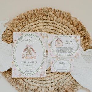 May include: Baby shower invitation set with a bunny theme. The invitation, book request, and diaper raffle cards feature floral accents and the text "Sweet Bunny." The invitation includes the name Amelia Miller and event details.