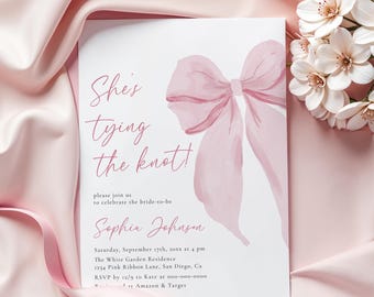 May include: A pink watercolor bow with the text "She's tying the knot!" on a white background. The text "Sophia Johnson" is below the bow. The text "Saturday, September 17th, 20xx at 4 pm" is below the name. The text "The White Garden Residence" is below the date. The text "1234 Pink Ribbon Lane, San Diego, Ca" is below the residence. The text "RSVP by 12/9 to Kate at 000-000-0000" is below the address. The text "Amazon & Target" is below the RSVP information.