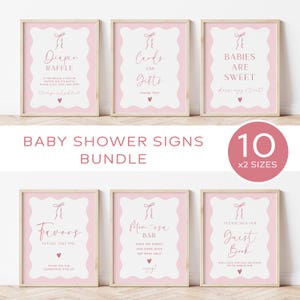 May include: Pink and white baby shower signs with a ballerina theme. The signs include "Diaper Raffle", "Cards and Gifts", "Babies are Sweet", "Favors", "Mimosas Bar", and "Guest Book".