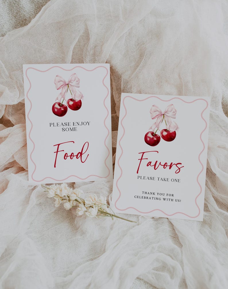 May include: Two white signs with pink borders and cherry illustrations. The top sign says "Please enjoy some Food" and the bottom sign says "Favors Please take one Thank you for celebrating with us!"