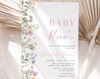 May include: A baby shower invitation with a floral border and the text "BABY in bloom" in pink. The invitation includes the name "Charlotte Jason" and details for the event, including the date, time, location, RSVP information, and registry details.
