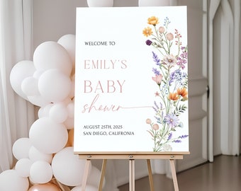 May include: Welcome to Emily's Baby Shower sign with a floral design featuring purple, pink, yellow, and orange flowers. The sign also includes the date August 25th, 2025 and the location San Diego, California.
