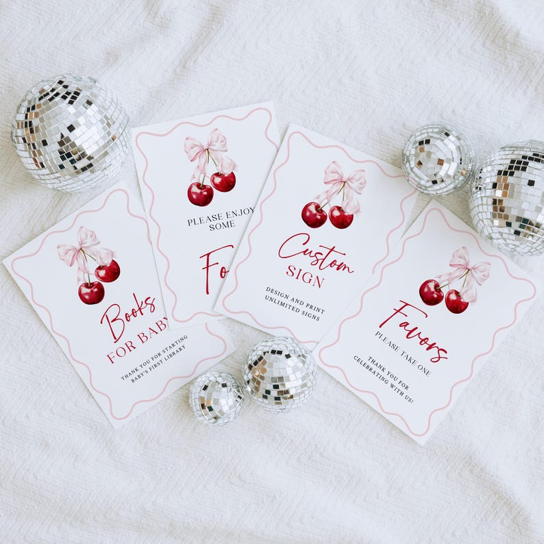 May include: Four printable signs with a cherry theme. The signs say "Books for Baby", "Please Enjoy Some", "Custom Sign", and "Favors Please Take One".