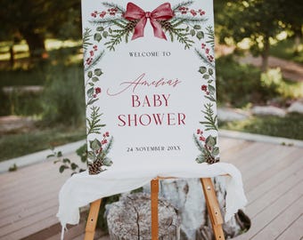 May include: Welcome to Amelia's Baby Shower sign with a red bow and green foliage. The sign is on a wooden easel and says "Welcome to Amelia's Baby Shower" with the date "24 November 20XX".