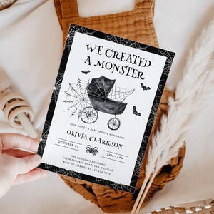 May include: A baby shower invitation with a Halloween theme. The black and white invitation features the text "WE CREATED A MONSTER" above a stroller illustration, spiderwebs, and bats. The invitation includes the baby's name, date, time, and location.