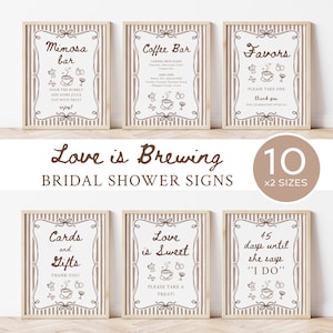 Puede incluir: Una colección de seis letreros rectangulares con rayas verticales de color marrón claro y centros blancos, con texto marrón e ilustraciones de café. Los letreros muestran frases como Mimosa bar, Coffee Bar, Favors, Cards and Gifts, Love is Sweet y 45 days until she says I DO, todos enmarcados por bordes decorativos de color marrón.