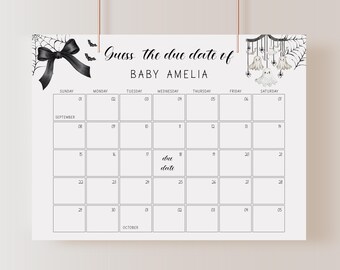 May include: A white Halloween-themed calendar with a black bow, spiderwebs, and ghost illustrations. The text reads "Guess the due date of BABY AMELIA." The calendar grid shows dates for September and October.