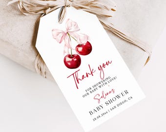 May include: A white thank you tag with a pink bow and two red cherries. The text reads "Thank you for showering our baby with love! Selenas Baby Shower 28.08.20xx | San Diego, CA"