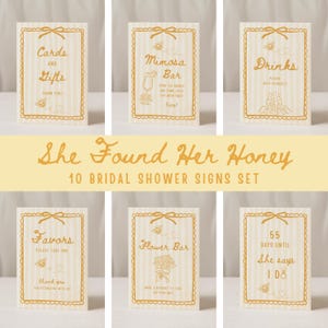 May include: A set of ten bridal shower signs with a cream and gold color scheme. Each sign has a decorative border and bow, with text such as "Cards and Gifts," "Mimosa Bar," and "Drinks." The signs are designed for a wedding celebration.