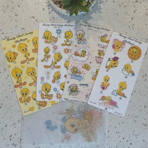May include: Four Tweety Bird Saving Challenge cards with various designs featuring the cartoon character. The cards have different backgrounds, including yellow, white, and pink, with illustrations of Tweety Bird in different poses. A clear envelope is at the bottom.