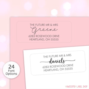 May include: Two white rectangular address labels with black text. The top label reads "THE FUTURE MR & MRS Greene 6283 ROSEWOOD DRIVE HEARTLAND, OH 55555". The bottom label reads "THE FUTURE MR & MRS daniels 6283 ROSEWOOD DRIVE HEARTLAND, OH 55555".
