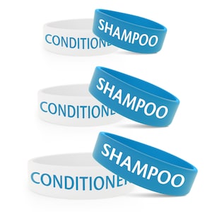 May include: Three white silicone wristbands with the word "CONDITIONER" printed on them.  Each wristband is partially covered by a blue silicone wristband with the word "SHAMPOO" printed on it.