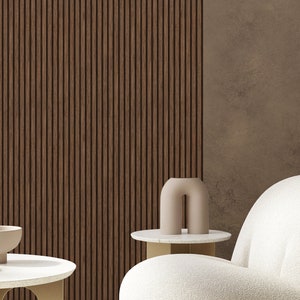 May include: An interior design scene featuring a white, rounded armchair, a small round side table, and a coffee table with two bowls. The background includes a wooden slatted wall and a brown textured wall.