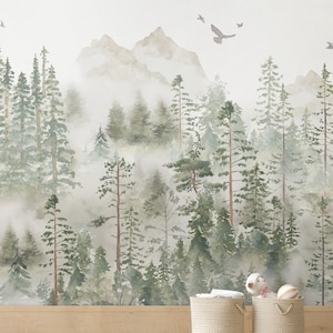 May include: Watercolor mural depicting a misty forest scene with tall evergreen trees, mountains, and flying birds. Two woven baskets sit in front of the mural, one with a white towel and the other with a stuffed animal and a ball.