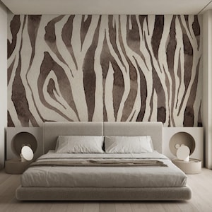 May include: A bedroom featuring a bed with a neutral-toned headboard and bedding. The focal point is a wall adorned with a zebra stripe pattern in shades of brown and beige. The room is decorated with minimalist bedside tables and lamps.