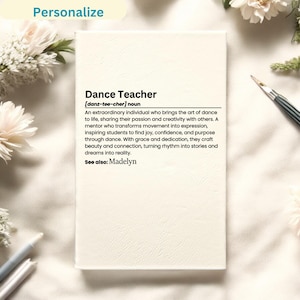 May include: A white notebook with a black leather-like cover and the text "Dance Teacher [danz-tee-cher] noun An extraordinary individual who brings the art of dance to life, sharing their passion and creativity with others. A mentor who transforms movement into expression, inspiring students to find joy, confidence, and purpose through dance. With grace and dedication, they craft beauty and connection, turning rhythm into stories and dreams into reality. See also: Madelyn" printed on it.