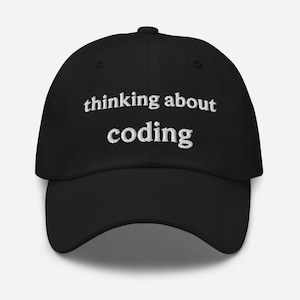 May include: Black baseball cap with white embroidered text that reads "thinking about coding".