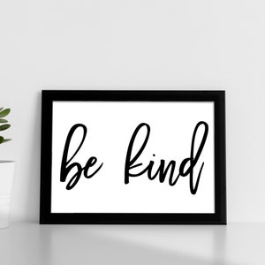 May include: Black and white framed print with the text "be kind" in a handwritten font.
