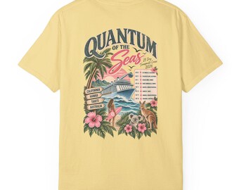 May include: A pale yellow t-shirt featuring a graphic on the back with the text Quantum of the Seas 25 Day Transpacific Cruise 2026. The design includes a cruise ship, palm trees, hibiscus flowers, a person with a surfboard, a koala, and a kangaroo.