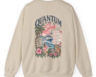 May include: A beige long-sleeve sweatshirt featuring a graphic on the back with the text Quantum of the Seas, 25 Day Transpacific Cruise 2026. The design includes a cruise ship, palm trees, a person with a surfboard, a koala, and a kangaroo.
