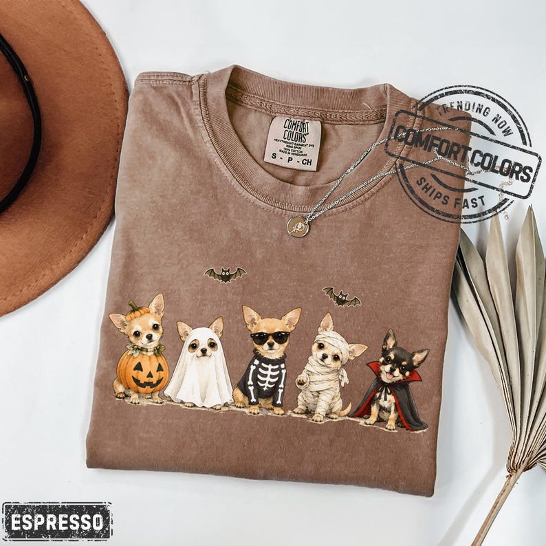 Chihuahuas in Costumes Halloween Comfort Colors Shirt featuring Five Chihuahuas and Jack-o'-lantern pumpkin costume illustration across the front. This design also works as a Halloween Party Tshirt, Watercolor Illustration Graphic Tee, or Halloween Lover Gift.-Espresso