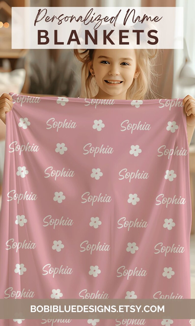 May include: A pink personalized blanket with a white floral pattern and the name "Sophia" repeated throughout.