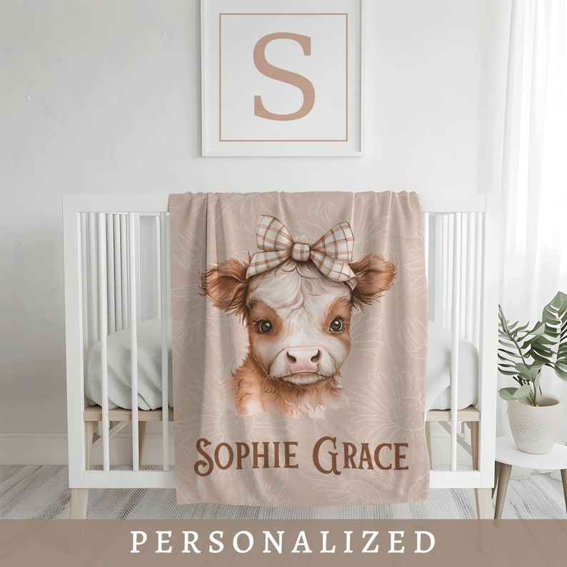 blanket hanging on a crib of a Highland Cow Personalized Name Blanket Gift for Baby Girl Name Blanket Personalized Newborn