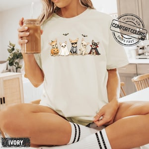 Chihuahuas in Costumes Halloween Comfort Colors Shirt featuring Five Chihuahuas and Jack-o'-lantern pumpkin costume illustration across the front. This design also works as a Halloween Party Tshirt, Watercolor Illustration Graphic Tee, or Halloween Lover Gift.-Ivory