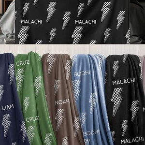 May include: Personalized kids blankets in various colors, featuring a lightning bolt pattern and personalized names. Available colors include black, dusk blue, surf blue, mocha, and fern green. The blankets are designed for children.