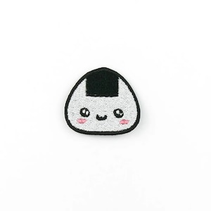 May include: An embroidered patch of a cartoon onigiri, a Japanese rice ball, with a smiling face and pink cheeks.